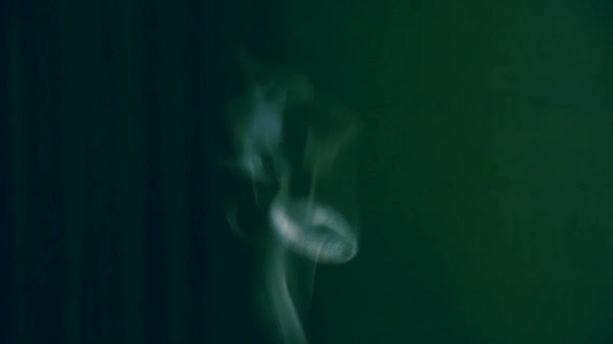 close-up of warm herbal tea with steam rising, soft lighting, peaceful atmosphere, minimal design